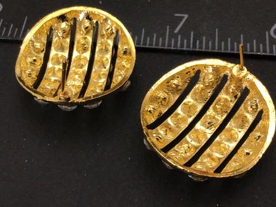 Sale Photo Thumbnail #207: Pair of round gold-tone pierced post earrings featuring rows of clear sparkling rhinestones separated by openwork stripes. Measure approximately 0.75 inches in diameter. Unmarked on reverse. Includes posts (earring backs not included). Good vintage condit