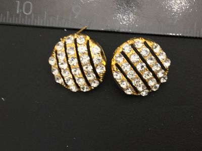 Sale Photo Thumbnail #208: Pair of round gold-tone pierced post earrings featuring rows of clear sparkling rhinestones separated by openwork stripes. Measure approximately 0.75 inches in diameter. Unmarked on reverse. Includes posts (earring backs not included). Good vintage condit