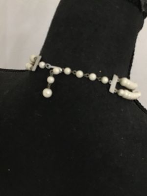 Sale Photo Thumbnail #66: Vintage mid-century double strand costume jewelry necklace featuring opaque white round beads interspersed with faceted clear glass accent beads. Includes an adjustable silver-tone tail chain clasp with bead drop. In good vintage condition with light, age