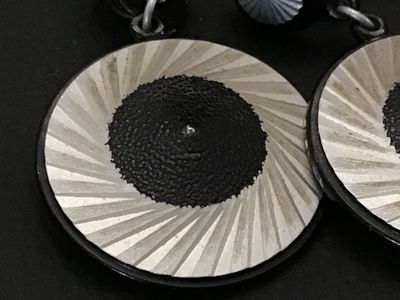 Sale Photo Thumbnail #177: Pair of vintage clip-on dangle earrings stamped 'W. GERMANY'. Feature a bold modern graphic design with concentric silver-tone radiating starburst patterns and textured black centers. Earrings measure approximately 2 inches in overall length. Clips show l