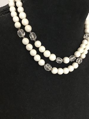 Sale Photo Thumbnail #65: Vintage mid-century double strand costume jewelry necklace featuring opaque white round beads interspersed with faceted clear glass accent beads. Includes an adjustable silver-tone tail chain clasp with bead drop. In good vintage condition with light, age