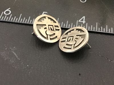 Sale Photo Thumbnail #172: A pair of round sterling silver stud earrings featuring a cut-out overlay design in a Southwestern / Hopi style geometric motif with textured recessed background. Measure approximately 3/4 inches in diameter. Minor surface wear and natural patina appropri
