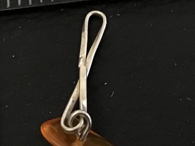 Sale Photo Thumbnail #85: Handcrafted silver tone wire-wrapped link bracelet featuring natural amber-colored chip beads spaced along twisted wire links. Measures approximately 7 to 7.5 inches in length with a spring ring closure. Appears to be in good pre-owned condition with mino