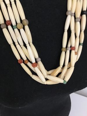 Sale Photo Thumbnail #8: Multi-strand Native American style hairpipe bead necklace featuring off-white smooth bone or horn pipe beads interspersed with colorful polished round stone accents (including agate and jasper colors). Features small seed beads near the secure metal hook 