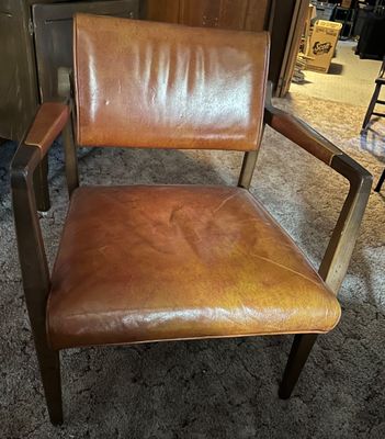 Sale Photo Thumbnail #40: Mid-century modern armchair featuring a dark wood frame with padded leatherette backrest, seat, and arm caps.