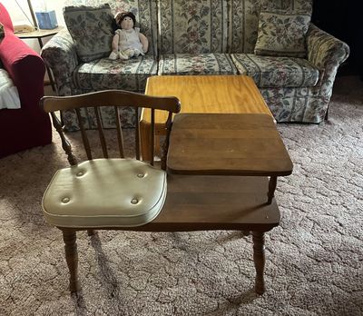 Sale Photo Thumbnail #42: Vintage mid-century wooden telephone gossip bench featuring a spindle back, built-in side table, and a tufted vinyl seat cushion. Hard to believe we would sit in these for hours talking on the home phone!