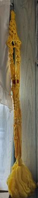 Sale Photo Thumbnail #163: Vintage 1970s yellow macramé plant hanger with red bead accents and a large fringed tassel.