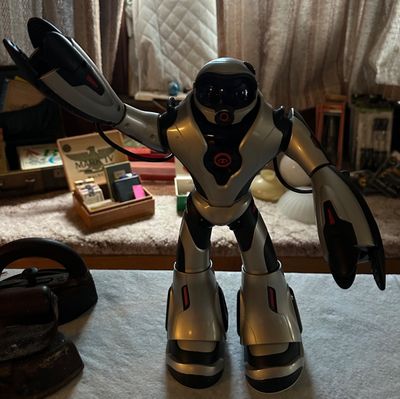 Sale Photo Thumbnail #63: WowWee Robosapien human-like toy robot in silver and black plastic, circa mid-2000s.