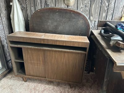 Sale Photo Thumbnail #37: Vintage mid-century wooden cabinet featuring sliding doors and open shelving. 