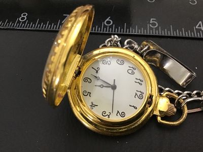 Sale Photo Thumbnail #202: Gold-tone hunter case pocket watch featuring a winter scene with a cardinal on the front cover and an ornate, detailed pattern on the back cover. The white dial displays unique, decorative stylized numerals. Includes a silver-tone chain with a belt clip. 