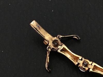 Sale Photo Thumbnail #92: Gold-tone over sterling silver (marked 925) tennis-style bracelet featuring bamboo-shaped links set with round clear cubic zirconia or glass stones. Box clasp with double safety latches. Measures approximately 7 inches in length. Pre-owned condition with 