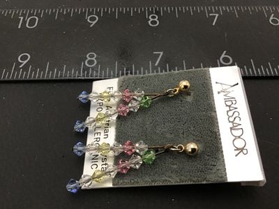 Sale Photo Thumbnail #46: Pair of Ambassador brand dangle pierces earrings featuring multi-color faceted Fine Austrian Crystal bicone beads (clear, green, pink, yellow, blue) on gold-tone ball studs. Still on original card marked 'Fine Austrian Crystal' and 'Hypo-Allergenic'. Drop