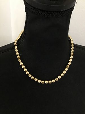 Sale Photo Thumbnail #152: A classic gold-tone sphere beaded necklace by Park Lane featuring polished metallic beads and a secure hook closure. Includes an attached 'Park Lane' logo hang tag. In good condition with bright finish and minor surface wear.