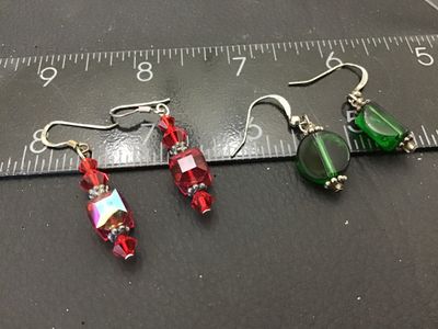 Sale Photo Thumbnail #113: Includes two pairs of handcrafted dangle drop earrings featuring wire fishhooks. One pair consists of faceted red crystal/glass beads with iridescent highlights and silver-tone spacer accents; the second pair features translucent green glass beads with si