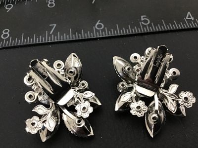 Sale Photo Thumbnail #144: Pair of vintage Judy Lee clip-on earrings featuring vibrant blue, green, and purple aurora borealis and marquise-cut rhinestones set in silver-tone metal floral settings. Marked Judy Lee on the clip backs. Each earring measures approximately 1.25 inches a