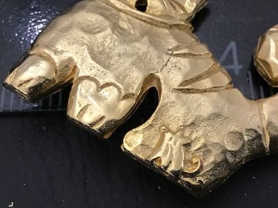 Sale Photo Thumbnail #82: Vintage gold-tone cat brooch by Ultra Craft featuring a hammered texture, curly tail, small rhinestone eyes, and a mouse accent near the bottom edge. Marked ULTRA CRAFT on the back. Measures approximately 2 inches wide by 2 inches tall. In good vintage co