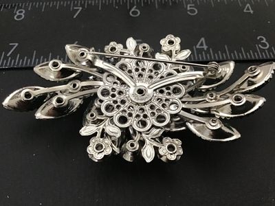 Sale Photo Thumbnail #141: Vintage Judy Lee costume jewelry brooch featuring vibrant blue, aqua, and green aurora borealis marquis cut and round faceted glass rhinestones prong-set in silver-tone metal. Measures approximately 3 inches wide. Features a filigree back setting with sta