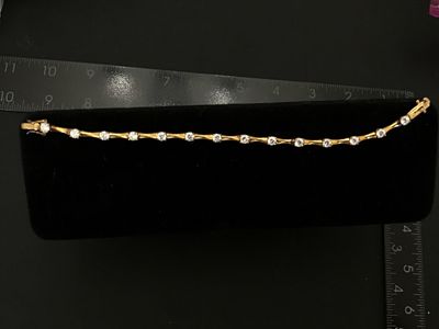 Sale Photo Thumbnail #91: Gold-tone over sterling silver (marked 925) tennis-style bracelet featuring bamboo-shaped links set with round clear cubic zirconia or glass stones. Box clasp with double safety latches. Measures approximately 7 inches in length. Pre-owned condition with 