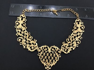 Sale Photo Thumbnail #7: A vintage Jose Barrera for Avon gold-tone collar statement necklace featuring intricate filigree scrollwork set with clear rhinestones. Includes an adjustable hook closure with an extender chain. Hallmarked 'Barrera for Avon' on the back. The necklace mea