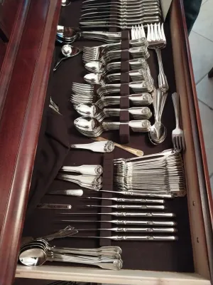 Sale Photo Thumbnail #39: Large sterling silver or silver-plate flatware set organized inside a felt-lined wooden silverware chest drawer.