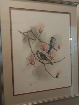 Sale Photo Thumbnail #67: Framed limited-edition art print featuring two songbirds perched on a blooming magnolia branch, signed by artist Cheryl Ann Evans and dated 1988.