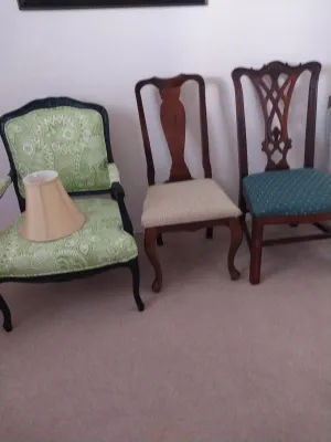 Sale Photo Thumbnail #55: Set of three assorted vintage accent chairs, including a green paisley upholstered armchair, a Queen Anne style dining chair, and a Chippendale style chair, paired with a beige lampshade.