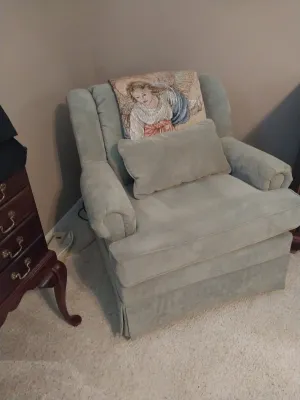 Sale Photo Thumbnail #79: Upholstered beige arm chair with rolled arms and matching lumbar pillow, decorated with an angel tapestry throw.