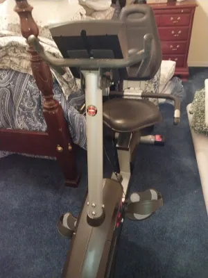 Sale Photo Thumbnail #69: Schwinn recumbent stationary exercise bike featuring an adjustable molded seat, digital display console, and foot straps.