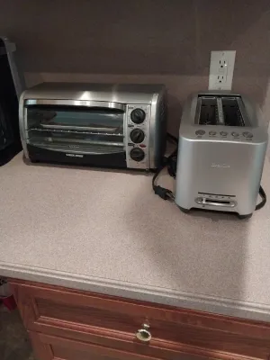 Sale Photo Thumbnail #30: Black & Decker stainless steel countertop toaster oven alongside a modern Breville 2-slice toaster.
