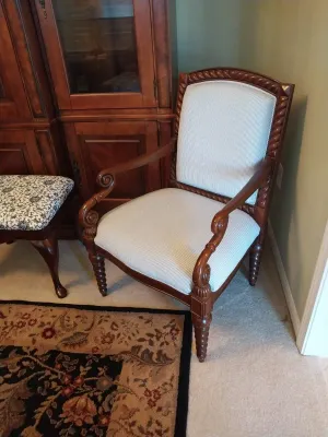 Sale Photo Thumbnail #54: Traditional wooden armchair featuring a rope-carved frame, scrolled armrests, and light blue striped upholstery.