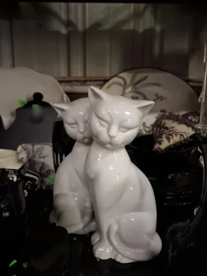 Pair of vintage white glazed ceramic seated cat figurines in a smooth, glossy finish.