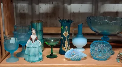 Collection of vintage blue and green glass tableware and decorative items, including a porcelain Victorian lady figurine, hand-painted...
