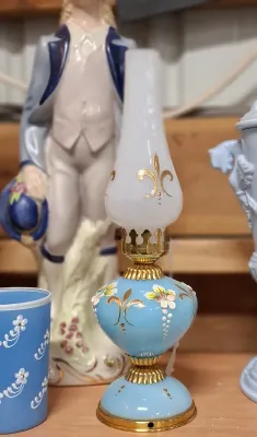Vintage miniature light blue glass oil lamp with hand-painted floral and gold fleur-de-lis accents and a white frosted glass chimney.