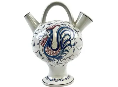 Sale Photo Thumbnail #107: Hand-painted Italian ceramic Botijo water vessel featuring a blue and red rooster motif with dual spouts and an arched handle.