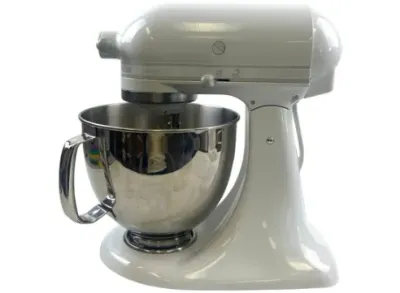 Sale Photo Thumbnail #125: White KitchenAid Artisan tilt-head stand mixer complete with a polished stainless steel mixing bowl with handle.