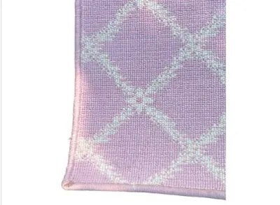 Sale Photo Thumbnail #54: Close-up detail of a pink area rug with a white geometric trellis pattern and finished edges.