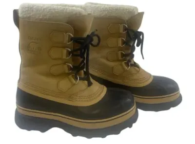 Sale Photo Thumbnail #145: Pair of vintage Sorel Caribou waterproof winter snow boots with tan leather upper, black rubber shell bottom, and plush faux-shearling lining.