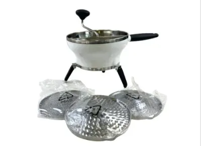 Sale Photo Thumbnail #126: OXO Good Grips food mill in white and stainless steel, featuring fold-out legs and three interchangeable disc grates in plastic packaging.