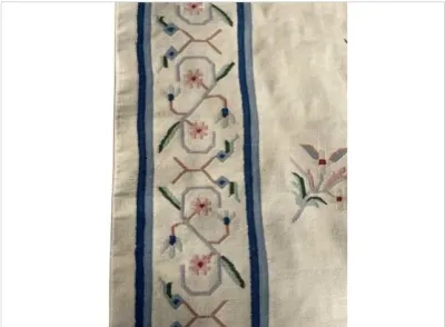 Sale Photo Thumbnail #56: Detail of an Art Deco Chinese Nichols-style wool rug featuring a cream field with blue borders and stylized pastel floral motifs.