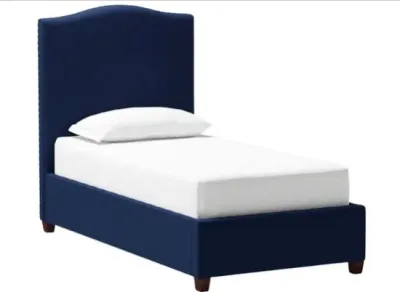 Sale Photo Thumbnail #12: Modern twin-size platform bed featuring navy blue upholstered fabric, arched headboard with nailhead trim, and low-profile wooden feet.