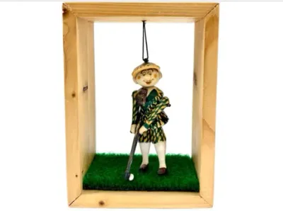 Sale Photo Thumbnail #157: Vintage novelty golfer figurine suspended inside a light wood shadow box frame with a faux-grass base.