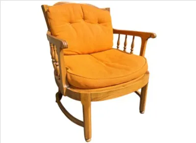 Sale Photo Thumbnail #18: Vintage solid wood barrel-back armchair featuring turned spindle accents and bright orange tufted seat cushions.