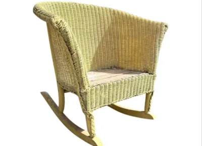 Sale Photo Thumbnail #22: Vintage pale yellow wicker rocking armchair featuring a curved barrel back and braided trim detail.
