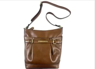 Sale Photo Thumbnail #151: Brown leather crossbody handbag with brass hardware detailing and an adjustable shoulder strap.