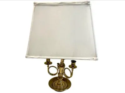 Sale Photo Thumbnail #68: Polished brass bouillotte table lamp featuring a two-light french horn design and a white trapezoidal lampshade.