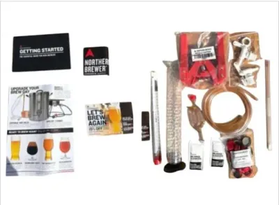 Sale Photo Thumbnail #118: Northern Brewer homebrewing starter kit accessories, including a bottle capper, hydrometer, tubing, caps, cleanser, and instructional manuals.