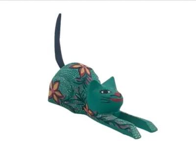 Sale Photo Thumbnail #156: Hand-painted Oaxacan wood carving of a stretching cat with floral motifs and vibrant green tones.