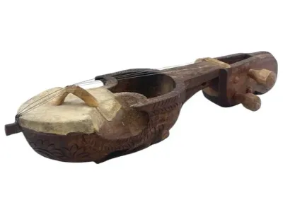 Sale Photo Thumbnail #98: Hand-carved wooden Sarangi string instrument featuring a stretched skin soundboard and detailed floral etchings on the body.