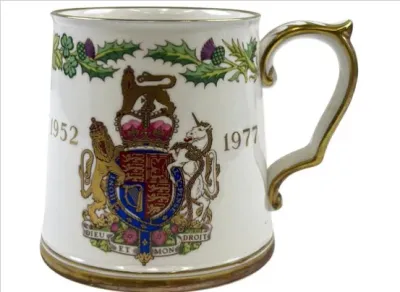 Sale Photo Thumbnail #106: A vintage fine bone china tankard mug commemorating Queen Elizabeth II's 1977 Silver Jubilee, featuring the Royal Coat of Arms and gilt trim.