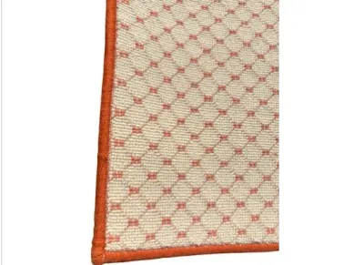 Sale Photo Thumbnail #50: Close-up of a woven area rug featuring a cream and orange geometric diamond grid pattern with bound edges.
